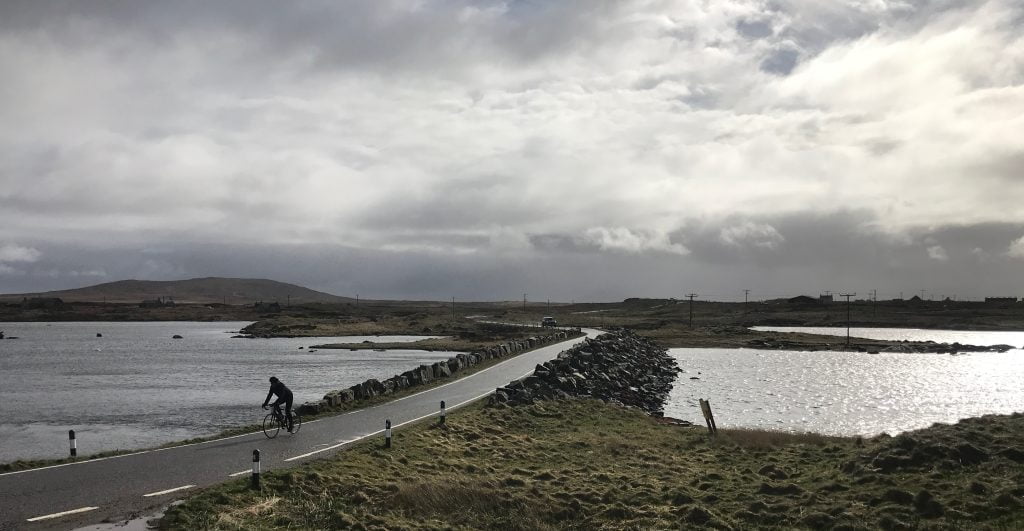 Cycling across causeway on the Outer Hebrides