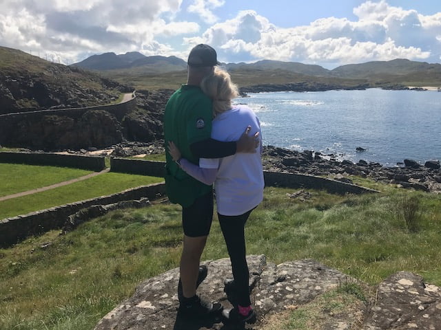 A couple of cyclists look out over the West Coast of Scotland