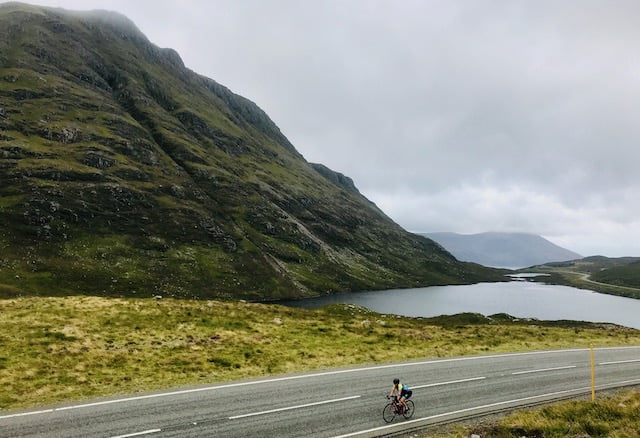 A cyclist riding over Clisham on Harris on the Hebridean Way