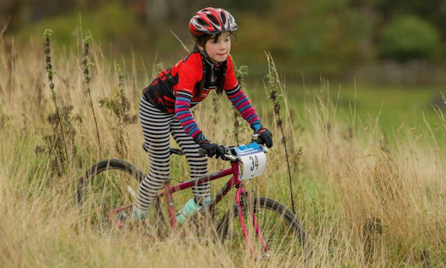 Bicycle race - A young girl races cross country on her mountain bike in Scotland
