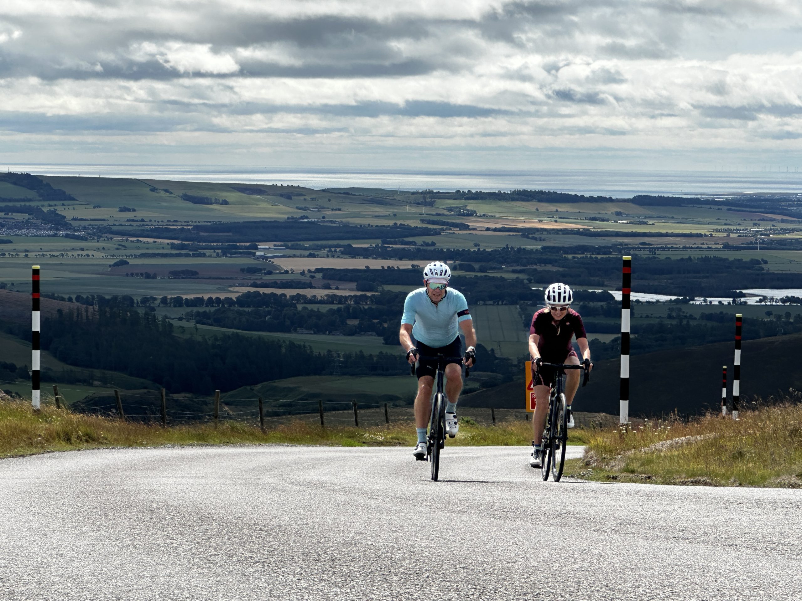 Two cyclists climb Cairn O'Mount
