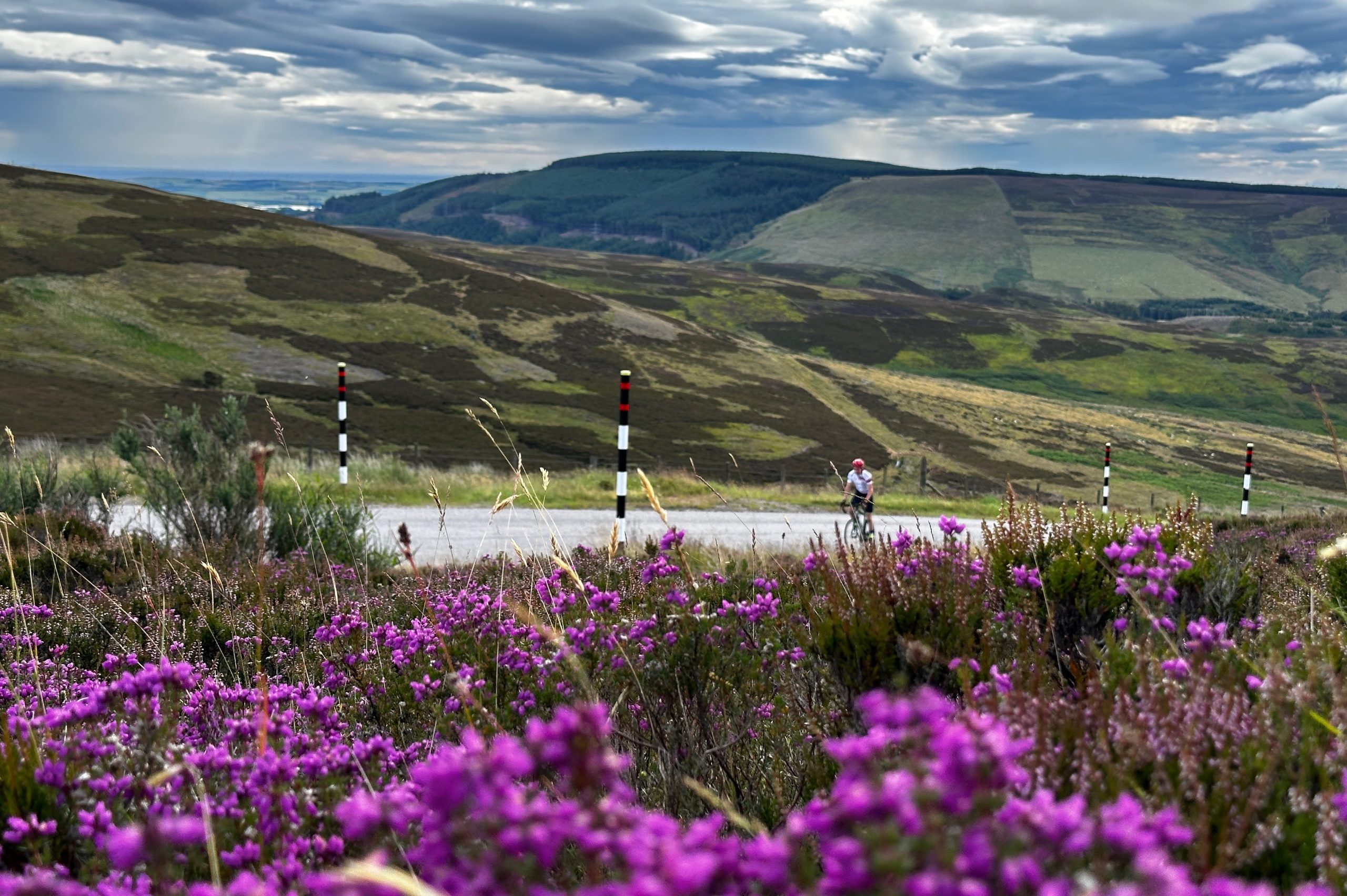 A cyclist rides up to the summit of Cairn O'Mount